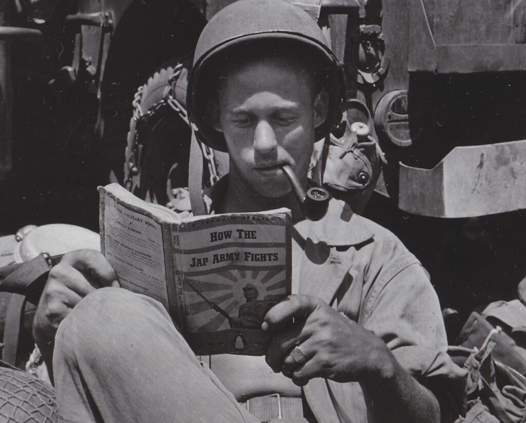 merican soldier reading a comics manual on japanese war tactics, world war ii